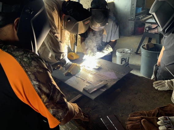 Ty Dewangyumptewa, 14, tries his hand at welding with guidance from Assitant 4-H Agent Josh Farella. Farella has helped start 4-H metalworking projects across Arizona.