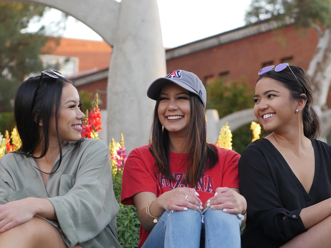 three students talking