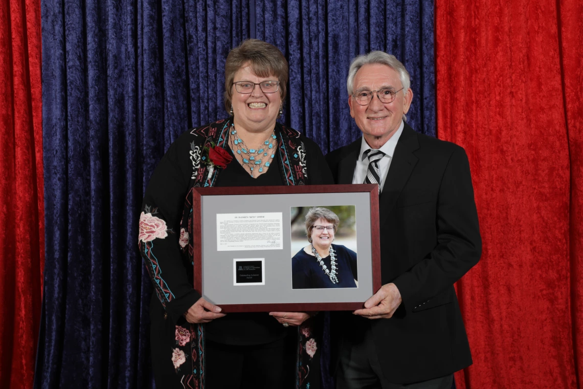 Greene with award & guest