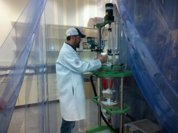 GlycoSurf team member Cliff Coss works with the company’s test reactor at the UA Tech Park